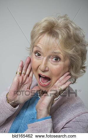 Stock Image - Close up of older Caucasian woman shouting. Fotosearch
