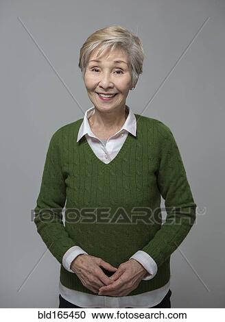 Stock Image - Close up of older Japanese woman smiling. Fotosearch