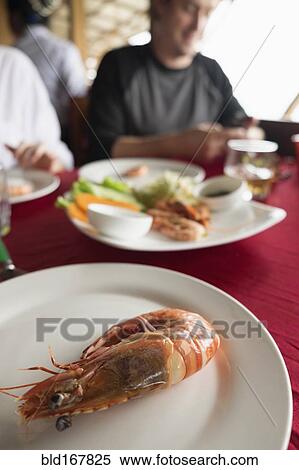 Close up of plate of shrimp on restaurant table View Large Photo Image Stock Photography - Close up of plate of shrimp on restaurant table. Fotosearch