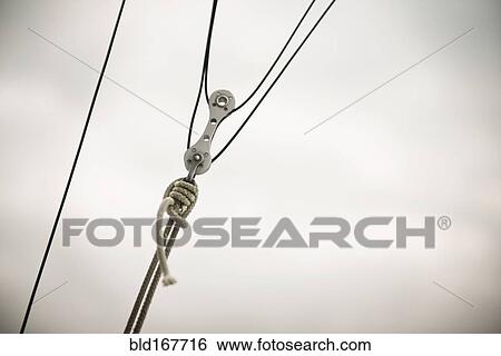 Close up of pulley and ropes under cloudy sky View Large Photo Image Stock Photograph - Close up of pulley and ropes under cloudy sky. Fotosearch