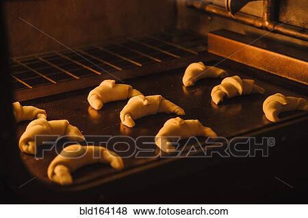 Stock Photo - Close up of rolls baking in oven. Fotosearch