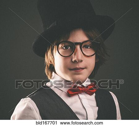 Close up of serious boy wearing top hat View Large Photo Image Stock Image - Close up of serious boy wearing top hat. Fotosearch