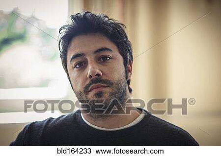Stock Image - Close up of serious Caucasian man indoors. Fotosearch