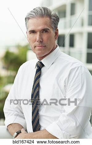 Close up of serious Caucasian businessman outdoors View Large Photo Image Picture - Close up of serious Caucasian businessman outdoors. Fotosearch