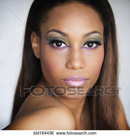 Stock Photograph - Close up of serious mixed race woman. Fotosearch