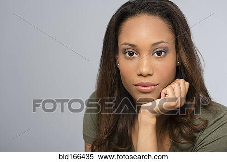 Stock Photography - Close up of serious Mixed race woman. Fotosearch