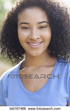 Stock Photograph - Close up of smiling Black woman outdoors. Fotosearch