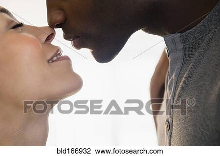 Close up of smiling couple kissing View Large Photo Image Stock Image - Close up of smiling couple kissing. Fotosearch