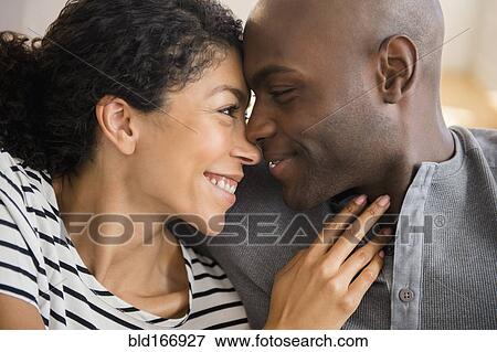 Stock Photo - Close up of smiling couple rubbing noses. Fotosearch