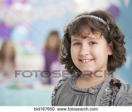 Close up of smiling girl at birthday party View Large Photo Image Stock Image - Close up of smiling girl at birthday party. Fotosearch