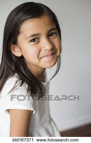 Close up of smiling girl indoors View Large Photo Image Stock Image - Close up of smiling girl indoors. Fotosearch