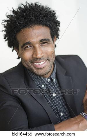 Stock Photography - Close up of smiling Hispanic businessman. Fotosearch