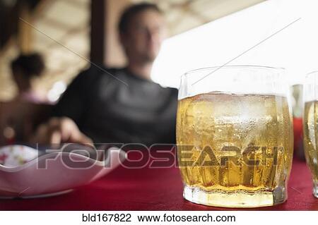 Stock Image - Close up of water beading on cocktail glass in restaurant. Fotosearch