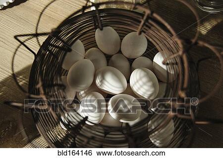 Close up of wire basket of eggs View Large Photo Image Stock Photograph - Close up of wire basket of eggs. Fotosearch