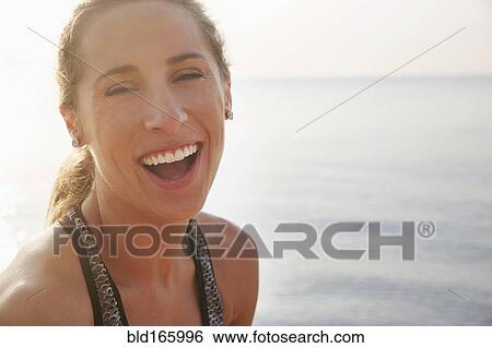 Close up of woman laughing on beach View Large Photo Image Stock Photograph - Close up of woman laughing on beach. Fotosearch