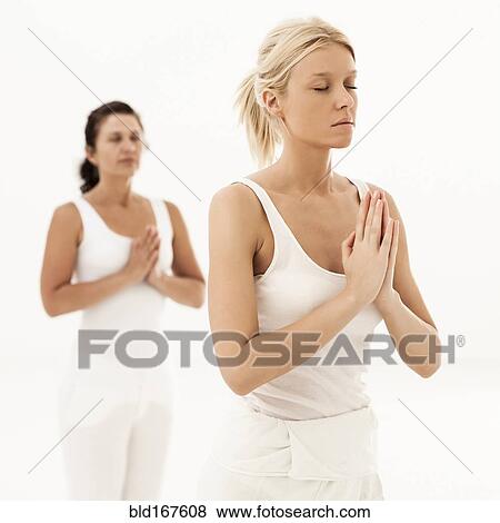 Close up of women meditating in yoga class View Large Photo Image Stock Photo - Close up of women meditating in yoga class. Fotosearch