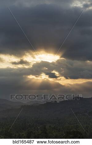 Stock Photo - Cloudy sky over remote landscape, Borobudur, Indonesia. Fotosearch