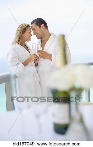 Couple drinking champagne on balcony table View Large Photo Image Stock Photo - Couple drinking champagne on balcony table. Fotosearch