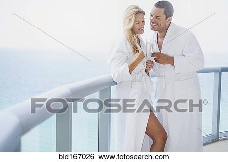Stock Photograph - Couple drinking champagne on balcony. Fotosearch