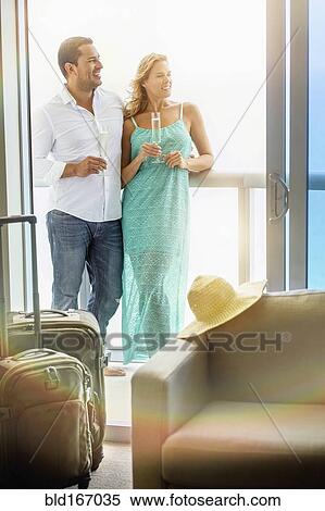 Stock Photography - Couple drinking champagne on hotel balcony. Fotosearch