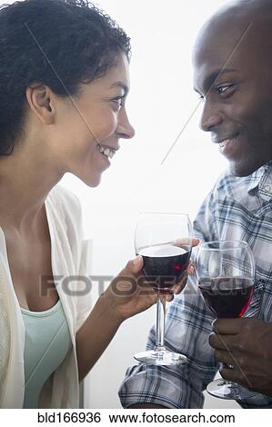 Stock Photograph - Couple drinking glasses of red wine. Fotosearch