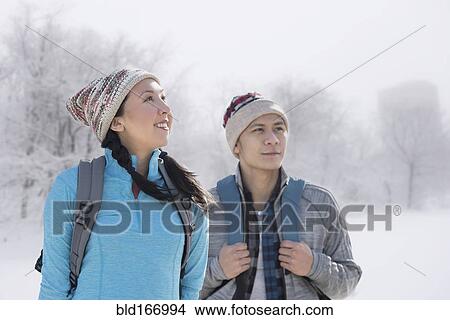Couple hiking in snowy field View Large Photo Image Picture - Couple hiking in snowy field. Fotosearch