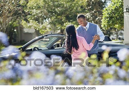 Couple hugging near convertible View Large Photo Image Stock Image - Couple hugging near convertible. Fotosearch