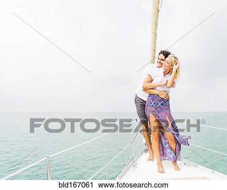 Couple hugging on deck of sailboat View Large Photo Image Stock Image - Couple hugging on deck of sailboat. Fotosearch