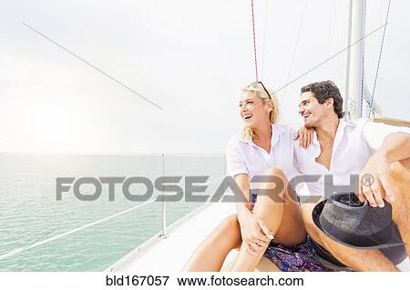 Stock Photo - Couple hugging on deck of sailboat. Fotosearch