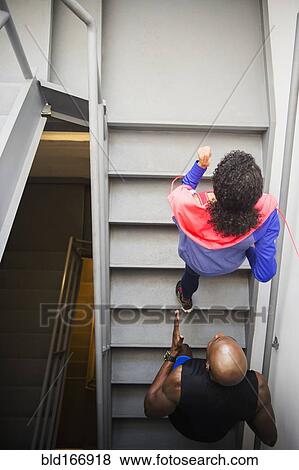 Couple jogging on staircase View Large Photo Image Stock Photo - Couple jogging on staircase. Fotosearch