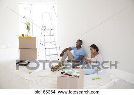 Picture - Couple relaxing in new home. Fotosearch