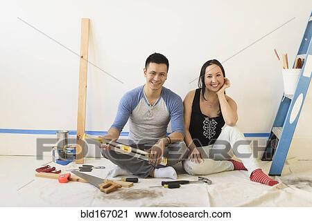 Couple sitting on floor during room remodeling View Large Photo Image Stock Image - Couple sitting on floor during room remodeling. Fotosearch