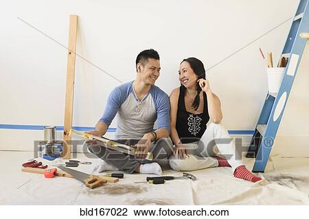 Couple sitting on floor during room remodeling View Large Photo Image Stock Image - Couple sitting on floor during room remodeling. Fotosearch