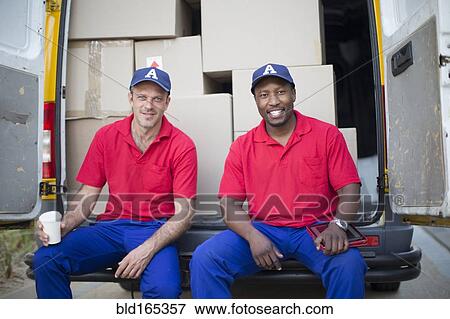 Delivery men sitting with packages in van View Large Photo Image Stock Photo - Delivery men sitting with packages in van. Fotosearch