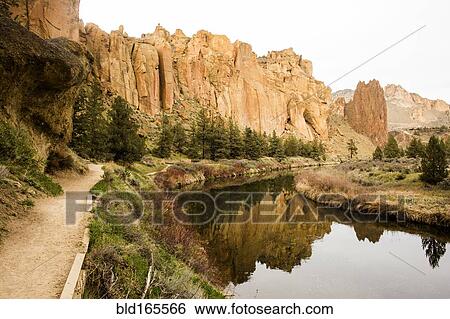 Stock Photograph - Desert cliffs reflecting in still river, Smith Rock State Park, Oregon, United States. Fotosearch