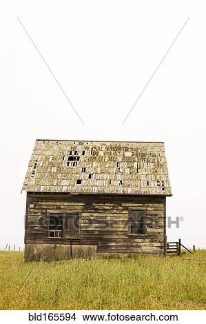 Picture - Dilapidated building in rural field. Fotosearch