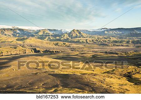 Stock Image - Distant hills and rock formations in remote landscape. Fotosearch
