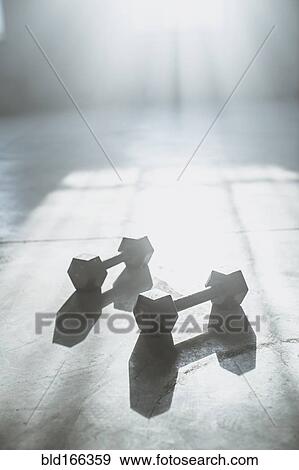 Dumbbell weights on floor in sunlight View Large Photo Image Stock Photo - Dumbbell weights on floor in sunlight. Fotosearch