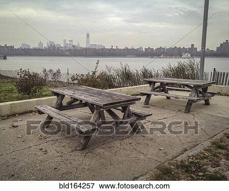 Empty picnic tables in urban park at waterfront View Large Photo Image Stock Photo - Empty picnic tables in urban park at waterfront. Fotosearch