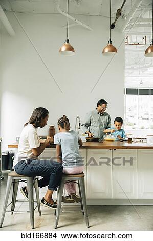 Picture - Family cooking in kitchen. Fotosearch