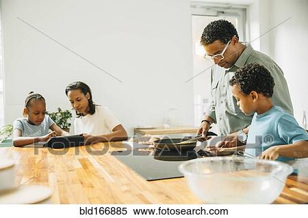Stock Photography - Family cooking in kitchen. Fotosearch