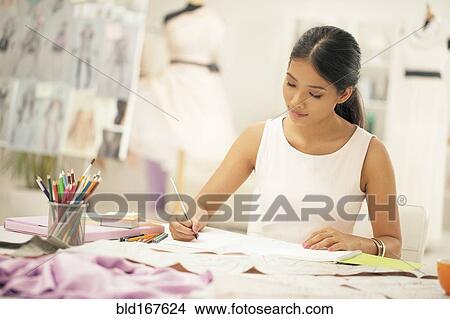 Picture - Fashion designer drawing in studio. Fotosearch