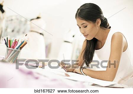 Fashion designer drawing in studio View Large Photo Image Stock Photo - Fashion designer drawing in studio. Fotosearch