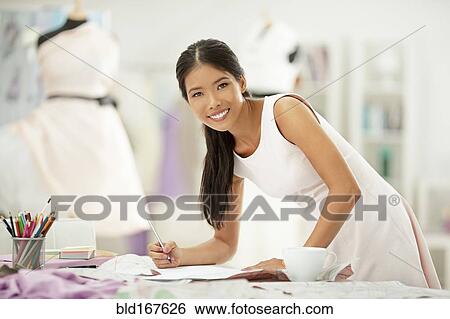 Fashion designer drawing in studio View Large Photo Image Stock Photograph - Fashion designer drawing in studio. Fotosearch