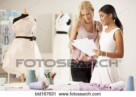 Fashion designers working together in studio View Large Photo Image Stock Image - Fashion designers working together in studio. Fotosearch