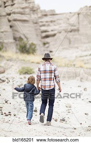 Father and son exploring desert rock formations View Large Photo Image Stock Image - Father and son exploring desert rock formations. Fotosearch