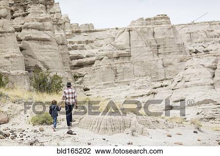 Father and son exploring desert rock formations View Large Photo Image Stock Image - Father and son exploring desert rock formations. Fotosearch