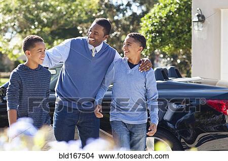 Father hugging sons near car View Large Photo Image Picture - Father hugging sons near car. Fotosearch