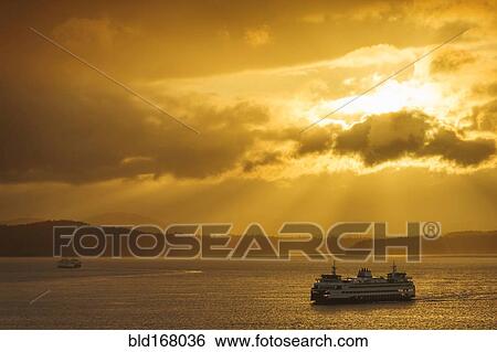 Ferry on ocean water under dramatic sky View Large Photo Image Stock Photograph - Ferry on ocean water under dramatic sky. Fotosearch