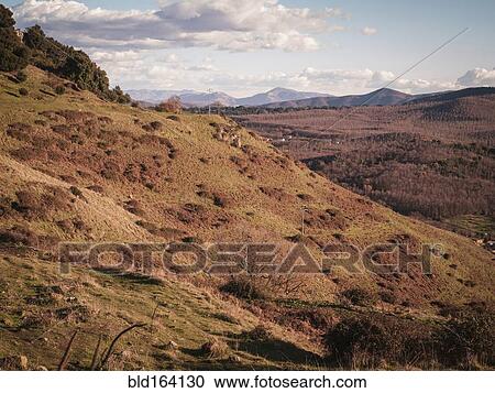 Stock Image - Fields and mountains in rural landscape. Fotosearch